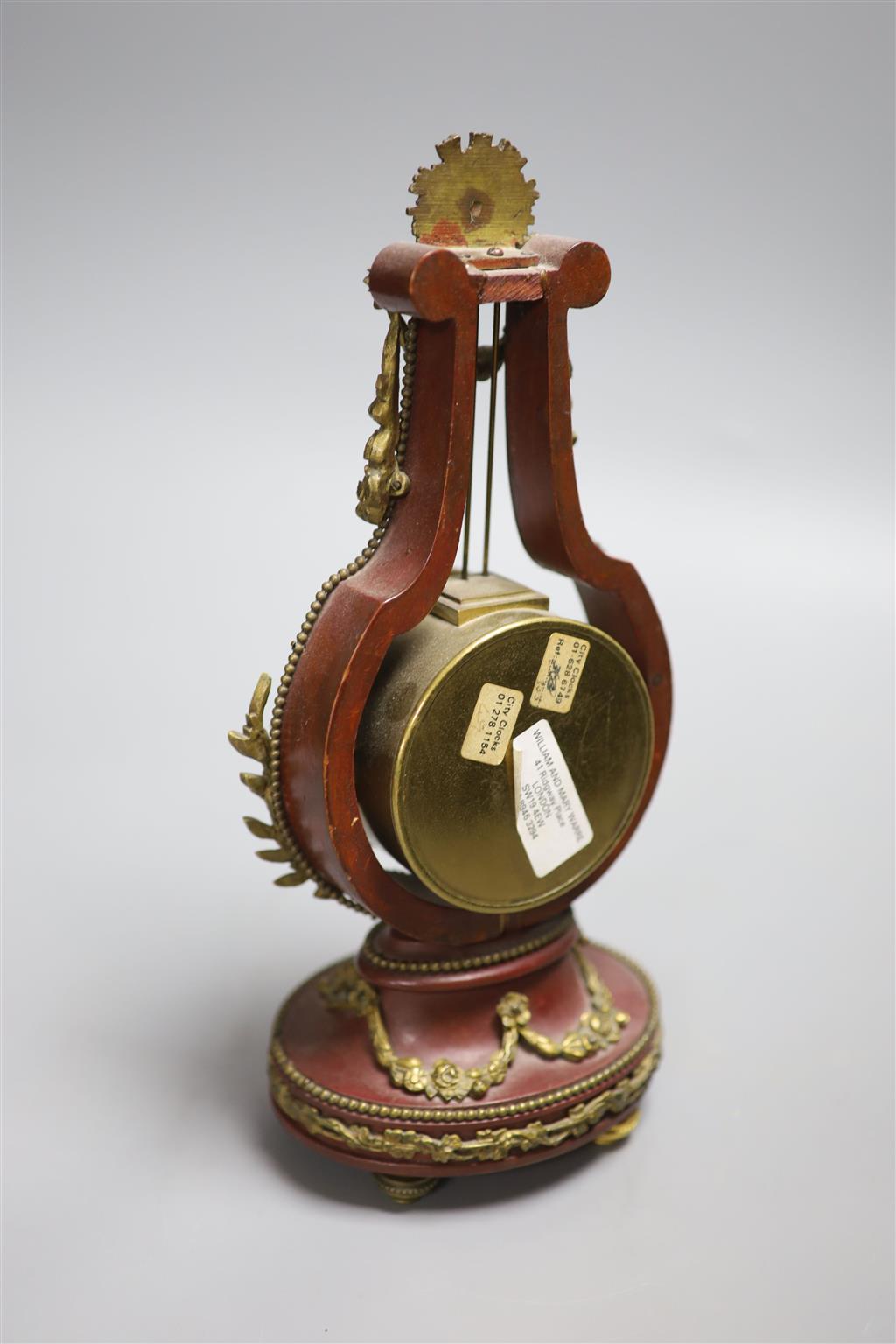 An early 20th century French lyre shaped mantel timepiece, with enamelled dial, height 26.5cm